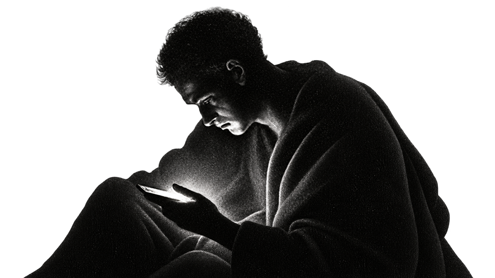 Jovem no escuro com o rosto iluminado pela tela do celular